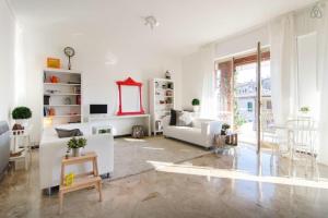 a living room with white furniture and a large window at Casa Vacanze Via Marconi in Marotta