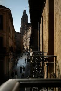 a group of people walking down a city street at Eunice Hotel Gastronómico in Salamanca