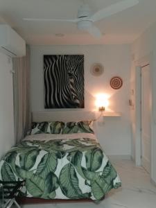 a bedroom with a bed with a zebra painting on the wall at Moneiba Centro in Córdoba