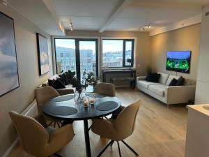 a living room with a table and chairs at TheNorthernExplorer Penthouse in Tromsø