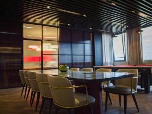 a dining room with a table and chairs at Radisson RED Belgrade in Belgrade