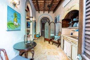 a kitchen with a table and a sink in a room at Charming Retreat in Old San Juan in San Juan