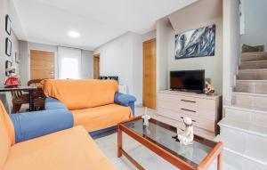 een woonkamer met een bank en een tv bij Gorgeous Home In Almazora With Wi-fi in Almazora