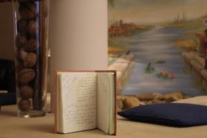 a book with writing on it sitting on a table at Hôtel Mélodie in Bellignat