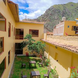 a view from the balcony of a building with tables and chairs at Inka's Haven Hotel in Ollantaytambo