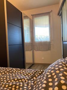 ein Schlafzimmer mit einem Bett und einem großen Fenster in der Unterkunft Appt T2 Sept Deniers avec clim in Toulouse