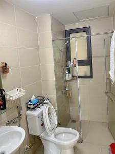 a bathroom with a toilet and a shower and a sink at Topaz twin in Bien Hoa