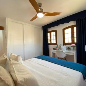 a bedroom with a bed with a ceiling fan at Luxury penthouse Apartment in Cuevas del Almanzora
