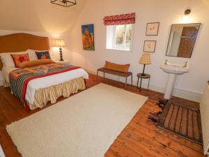 a bedroom with a bed and a sink at The Old Rectory Coach House in Rathmullan