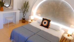 a bedroom with a large bed and two lamps at Papafotis Apartments & Suites in Alinda