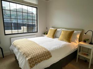 a bedroom with a bed with a large window at The Cottage Central Newcastle in Newcastle