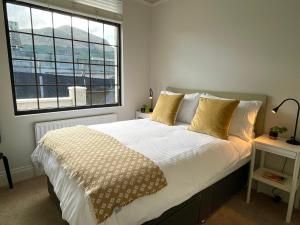 a bedroom with a bed with a large window at The Cottage Central Newcastle, 4-Star Accommodation by Tourism Northern Ireland in Newcastle