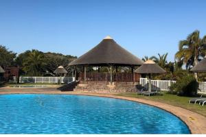 a large swimming pool with a gazebo at Lodge 62 Unparalleled view. in Mossel Bay