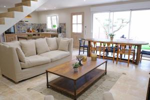 a living room with a couch and a table at charming house with private pool in the heart of the village of aureille in the alpilles, 6 people. in Aureille