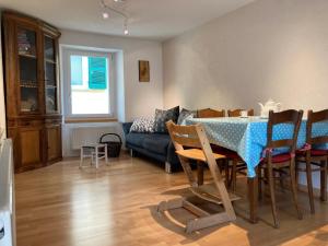 a living room with a table and a couch at Appartamento Evelina in Airolo