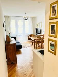 a living room with a kitchen and a dining room at Apartament Jan III Sobieski in Rzeszów