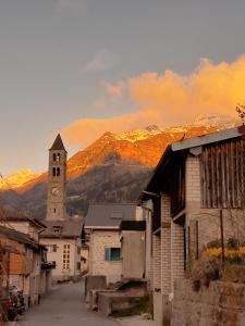 a small town with a church and a mountain at Appartamento Evelina in Airolo
