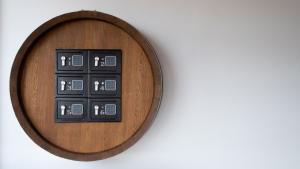 a wooden remote control on a white wall at Penzion pod Kraví horou in Bořetice