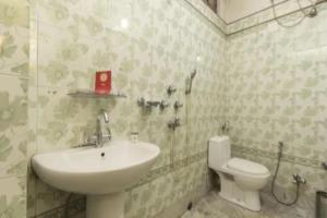 a bathroom with a sink and a toilet at Hotel North Point Inn Darjeeling in Darjeeling