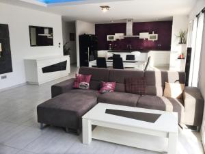 a living room with a couch and a table at very pretty contemporary villa with heated pool located in aureille in the alpilles, close to the center on foot. sleeps 4. in Aureille