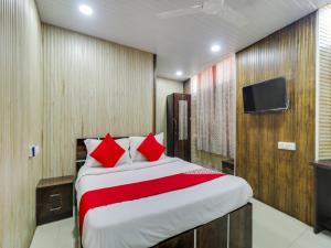 a bedroom with a large bed with red pillows at Super OYO Flagship Hotel Diamond in Mumbai