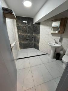 a bathroom with a shower and a sink at GRAND LOFT OTEL in Bursa