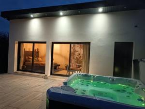 a jacuzzi tub in the middle of a house at lovebirds spa in Vincey