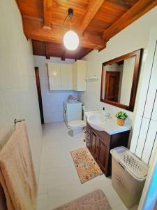 a small bathroom with a toilet and a sink at Casina Playa de Rodiles in Villaviciosa