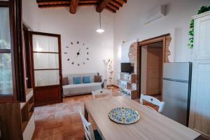 a living room with a table and a refrigerator at Agriturismo Il Sogno in Castiglione del Lago