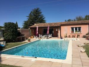 a swimming pool in the yard of a house at beautiful vacation home with pool located in robion with a pretty view on the luberon. 8 people. in Robion en Luberon