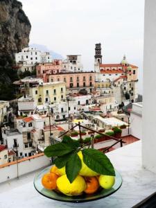 a plate of fruit with a view of a city at Panoramic house Atrani 5 Amalfi Antica appartamenti in Atrani