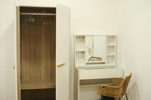 a door to a closet with a mirror and a chair at 2BR Stylist Rare Find China Town in Bangkok +68 photos