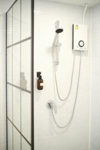 a shower in a bathroom with a glass door at 2BR Stylist Rare Find China Town in Bangkok