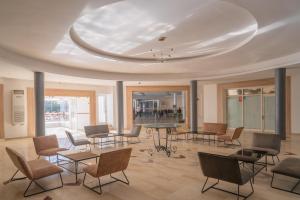 a large room with chairs and tables and a ceiling at Acquaviva village in Gammarth