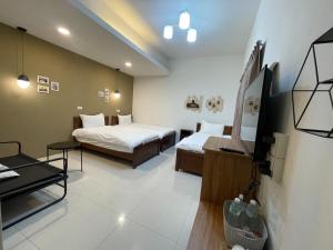 Voodi või voodid majutusasutuse 屏東潮州民宿-綠品文旅Green Inn toas