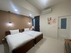 Voodi või voodid majutusasutuse 屏東潮州民宿-綠品文旅Green Inn toas
