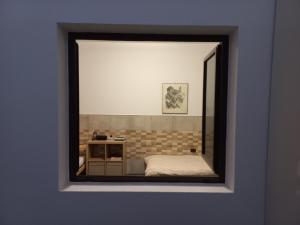 a view of a bedroom through a mirror at Sunset house in Soo