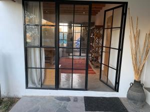 an open door to a room with glass at Mesquite Tree Retreat in San Miguel de Allende