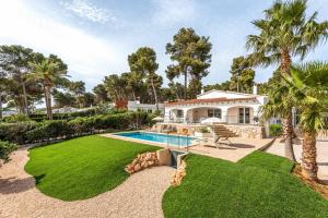 een huis met een zwembad en palmbomen bij Villa Adriana Tomas in Santo Tomás
