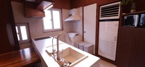a kitchen with a sink and a counter top at Studio Sum in Seoul