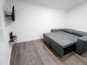 a living room with a couch and a tv at Apartment in Semeador in Portalegre