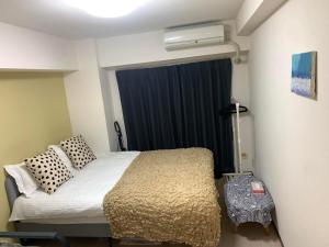 Postel nebo postele na pokoji v ubytování 诚信东新宿