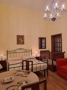 a bedroom with two beds and a chandelier at B&B Villa Damiano in Copertino