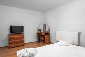 Ένα ή περισσότερα κρεβάτια σε δωμάτιο στο Central Apartament Predeal Nr 7 +5 φωτογραφίες