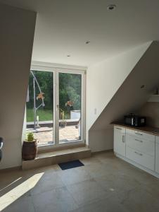 a kitchen with an open window and a staircase at Ferienwohnung Blick Schloss Prunn in Riedenburg
