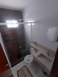 a bathroom with a shower and a toilet and a sink at Paraíso Praia Bela in Pitimbu