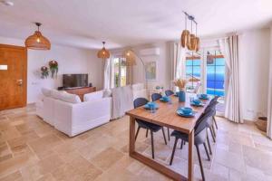 a living room with a table and a couch at Villa Blue, LaVanta, Kalkan in Kalkan