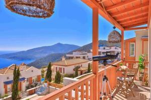 a balcony of a house with a view of the ocean at Villa Blue, LaVanta, Kalkan in Kalkan