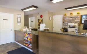 a restaurant with a counter with food and drinks at Bon Voyage Inn in Prince George