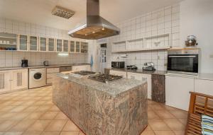 a large kitchen with a large island in the middle at Awesome Home In Kolocep With Heated Swimming Pool in Koločep